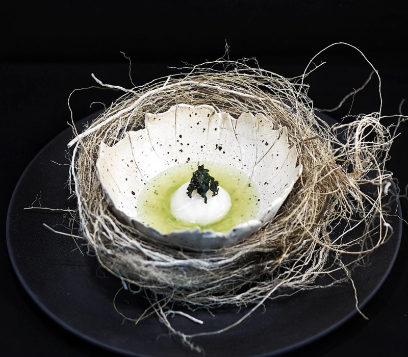 Artful Nordic dish with caviar and herbal emulsion, served in a handcrafted shell bowl – a signature creation for Michelin-inspired yacht dining in Monaco.